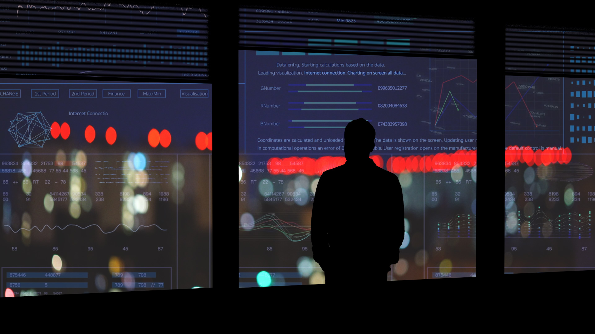 A man in silhouette at a window of market data and city lights at night